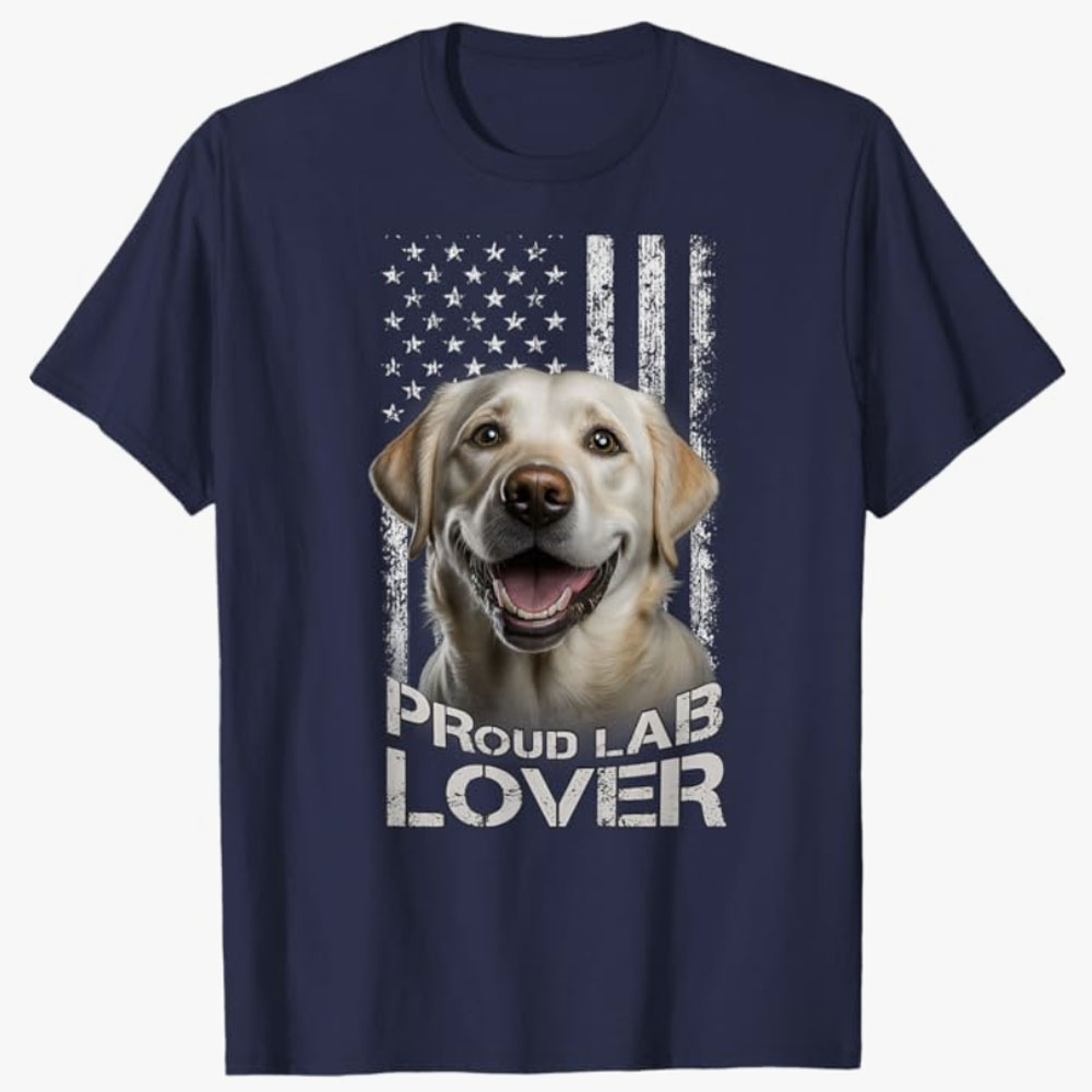 Navy T-shirt featuring a smiling yellow Labrador Retriever in front of a distressed American flag with the text Proud Lab Lover, celebrating patriotism and affection for Labrador dogs.