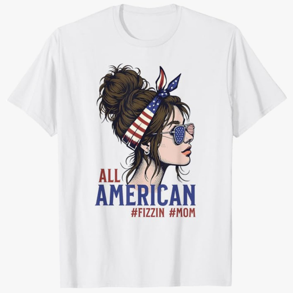 A white T-shirt features a stylized woman wearing American flag sunglasses and a matching headband, with the text All American #Fizzin #Mom. The design celebrates patriotic pride and a fun, confident mom vibe.