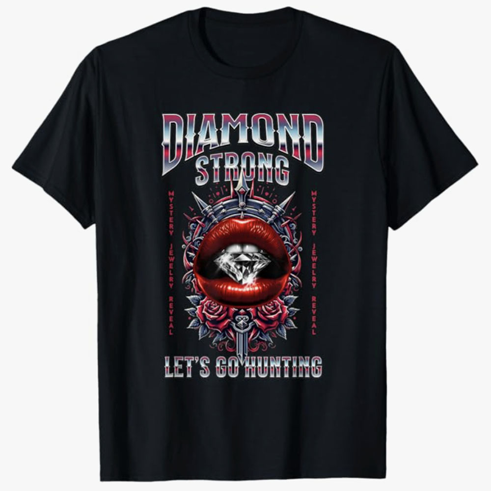 A black T-shirt features a bold design with metallic lettering reading Diamond Strong above a dramatic graphic of lips holding a sparkling diamond, surrounded by roses and ornate detailing. The phrase Let’s Go Hunting adds an edgy, adventurous tone centered around the excitement of finding dazzling gems.