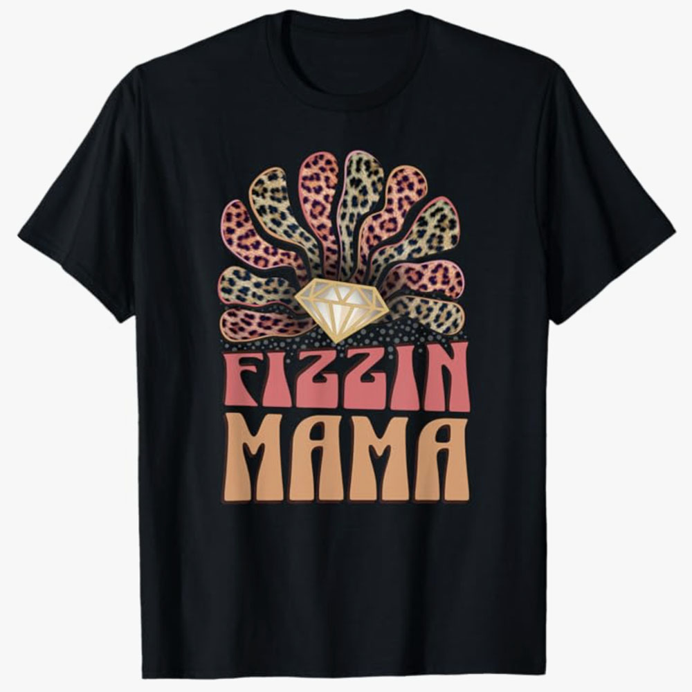 A black T-shirt features the phrase Fizzin Mama beneath a sparkling diamond and a fan of leopard-print shapes. The design conveys bold style, confidence, and a fun, fierce personality.