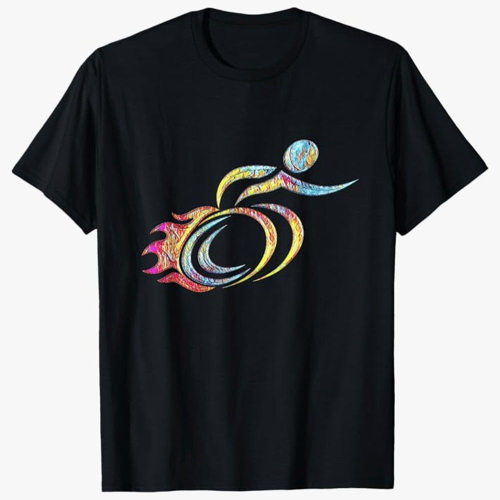 A black T-shirt features a colorful, abstract wheelchair symbol with flame-like motion elements suggesting speed and energy. The design represents empowerment, strength, and dynamic movement within the disability community.