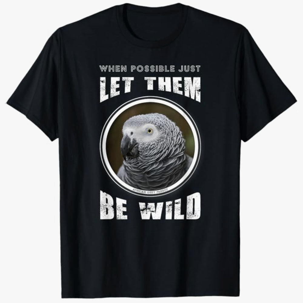 A black T-shirt features an African grey parrot in a circular frame with the words “When possible just let them be wild.” The design promotes wildlife respect and the importance of allowing animals to live freely in their natural habitats.
