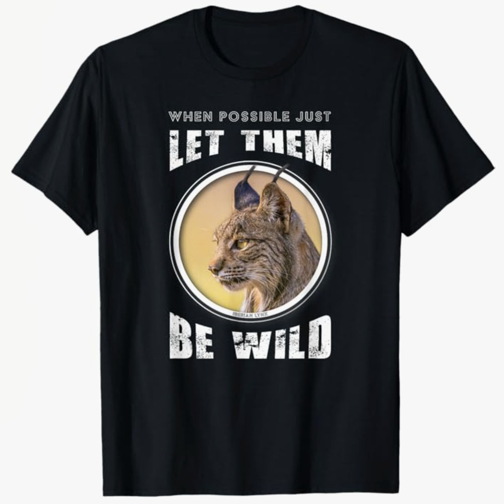 A black T-shirt features an Iberian lynx inside a circular frame with the words “When possible just let them be wild.” The design promotes wildlife conservation and respect for animals living freely in nature.