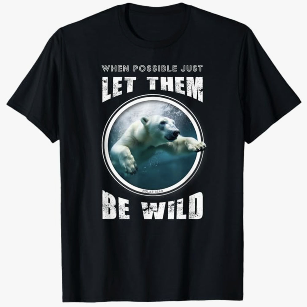 A black T-shirt features a polar bear swimming inside a circular frame with the words “When possible just let them be wild.” The design emphasizes wildlife conservation and respecting animals’ freedom in their natural habitats.