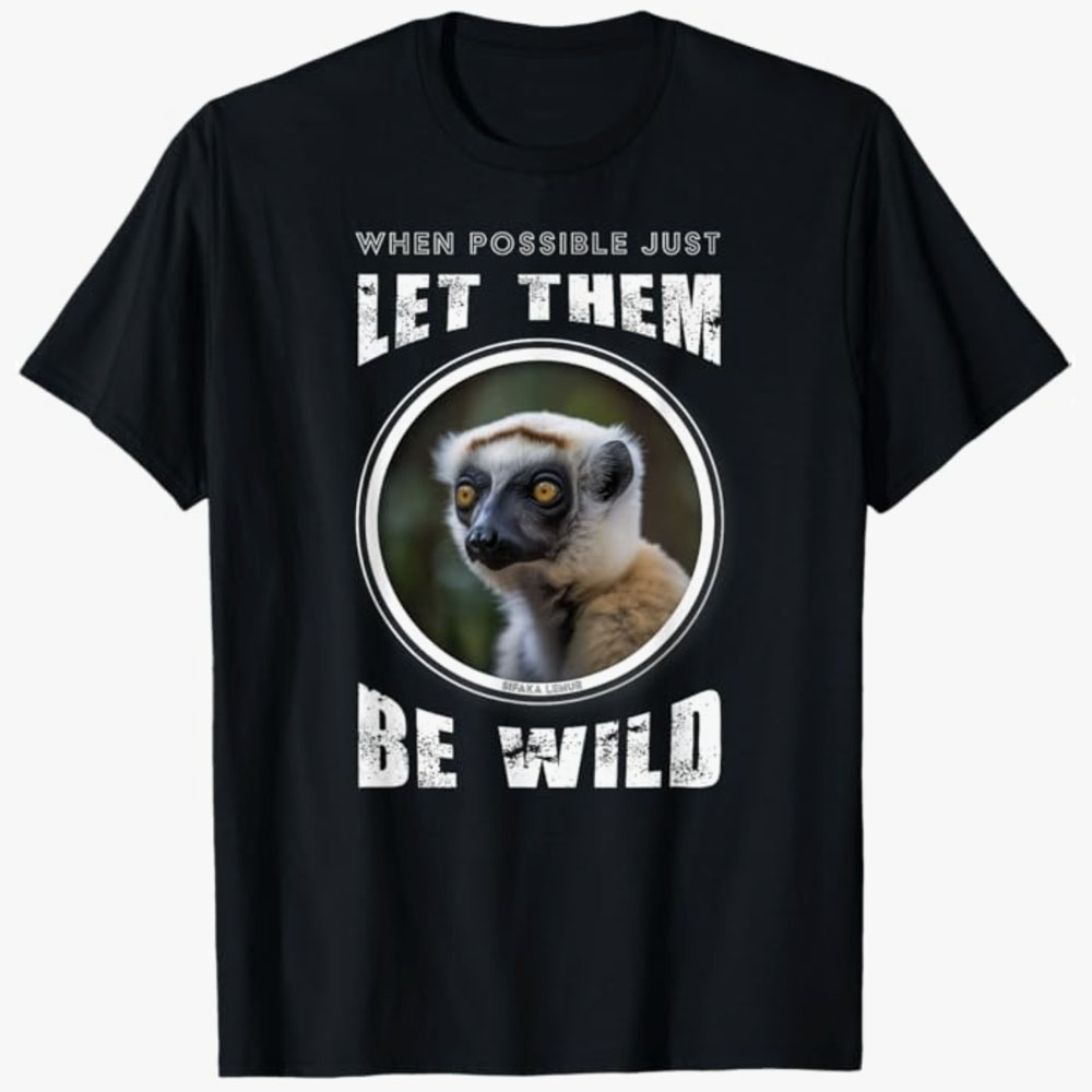 A black T-shirt features a lemur inside a circular frame with the words “When possible just let them be wild.” The design promotes wildlife respect and allowing animals to live freely in their natural habitats.
