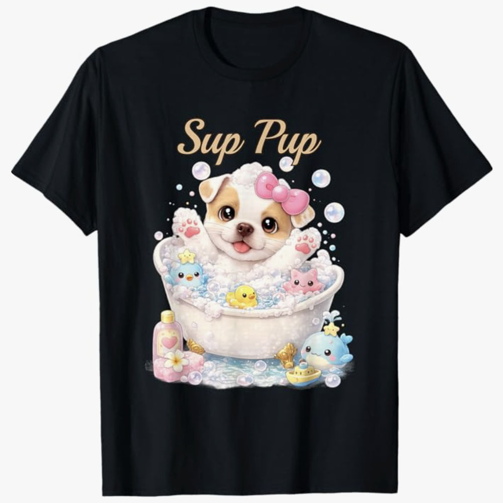 A black T-shirt features a cute puppy with a pink bow happily taking a bubbly bath surrounded by toy animals and bubbles with the phrase Sup Pup, creating a playful and adorable design.