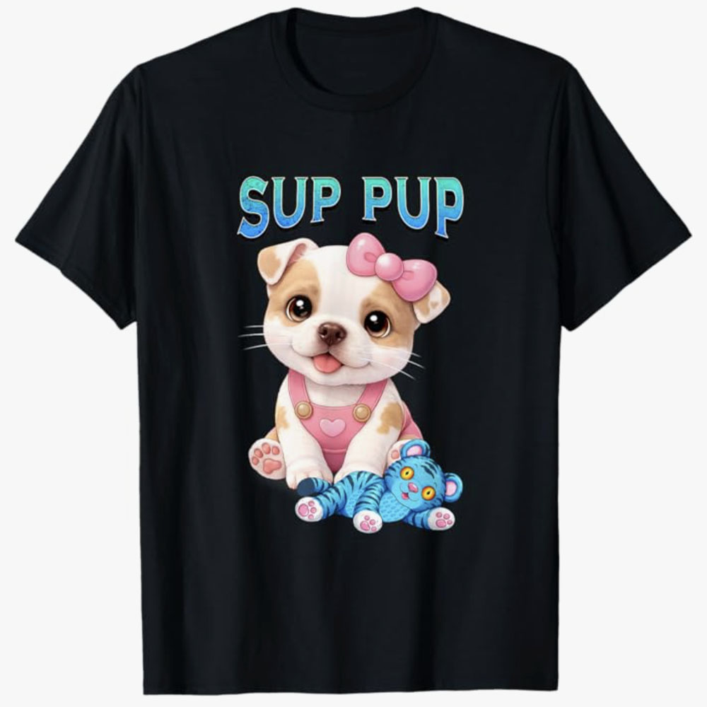 A black T-shirt features a cute puppy with a pink bow sitting next to a blue stuffed toy with the phrase Sup Pup, creating a playful and adorable puppy-themed design.
